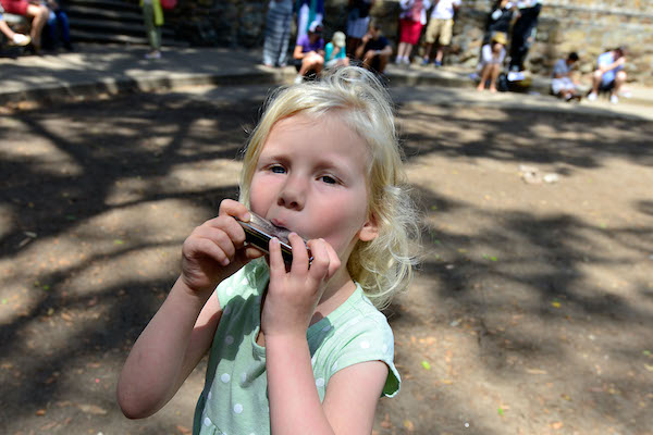 Girl playing harmonica at Make Music San Diego